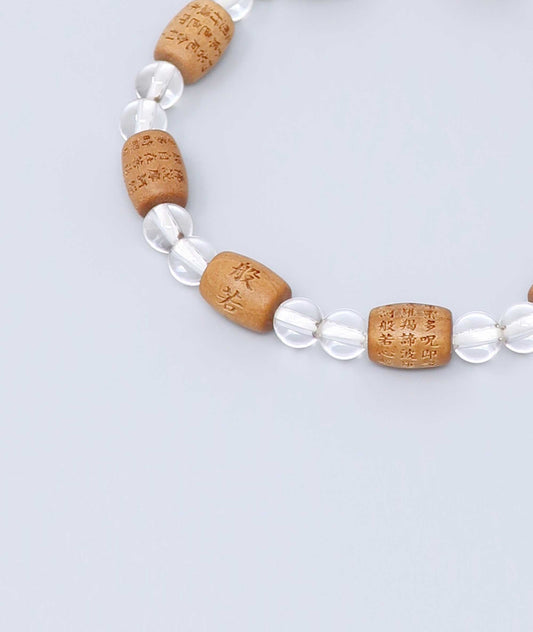 Sandalwood bracelet engraved with the Heart Sutra and accented with a Clear Quartz bead—handcrafted for spiritual protection and harmony. Handcrafted in Kyoto Japan Kanbe Juzu