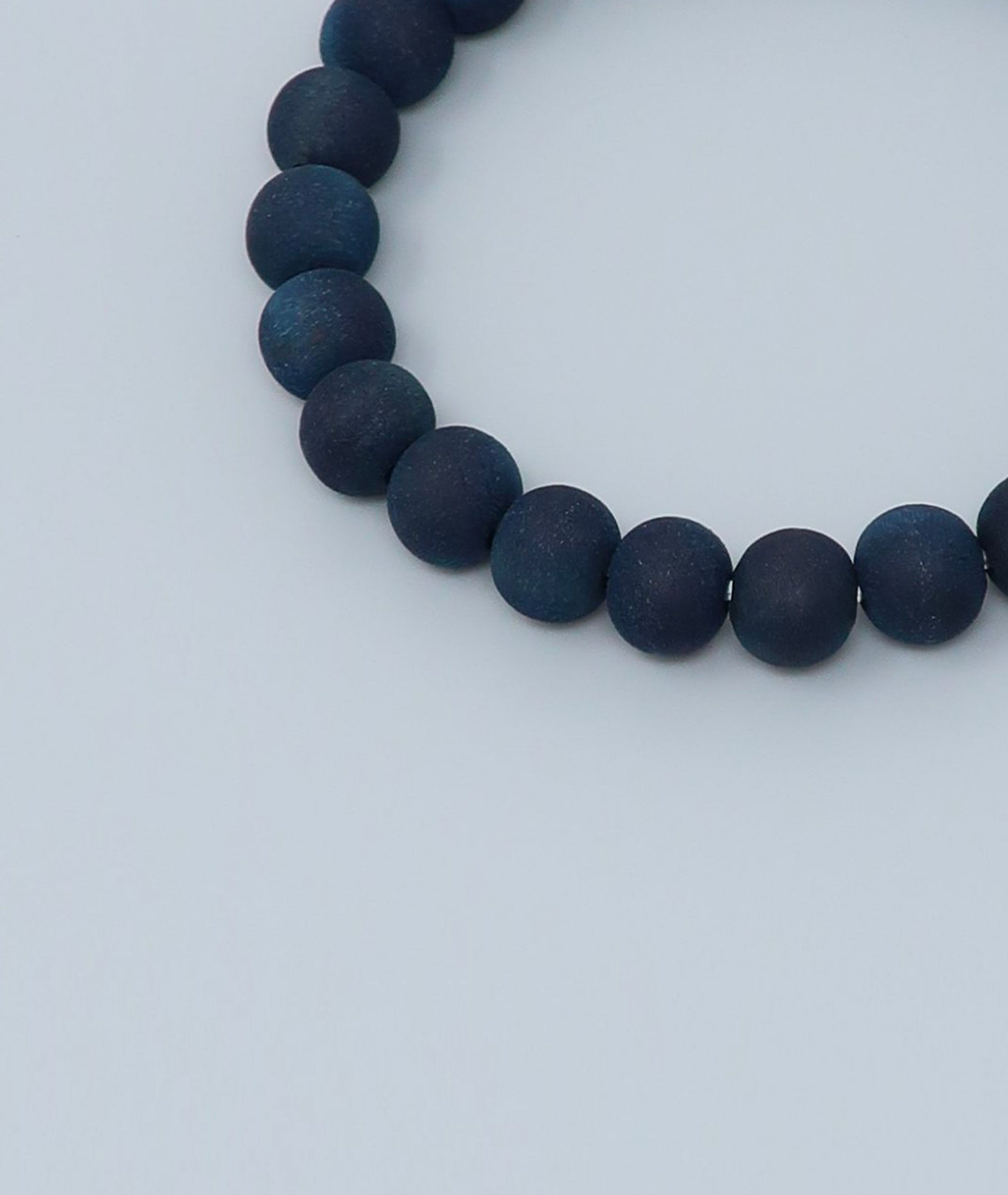 Women's indigo pearl bracelet made from mountain cherry wood, handcrafted in Japan using traditional Sho-Aizome indigo dyeing by Kanbe Juzu of Kyoto; spiritual accessory inspired by samurai, ideal for yoga, prayer, or as a premium gift.
