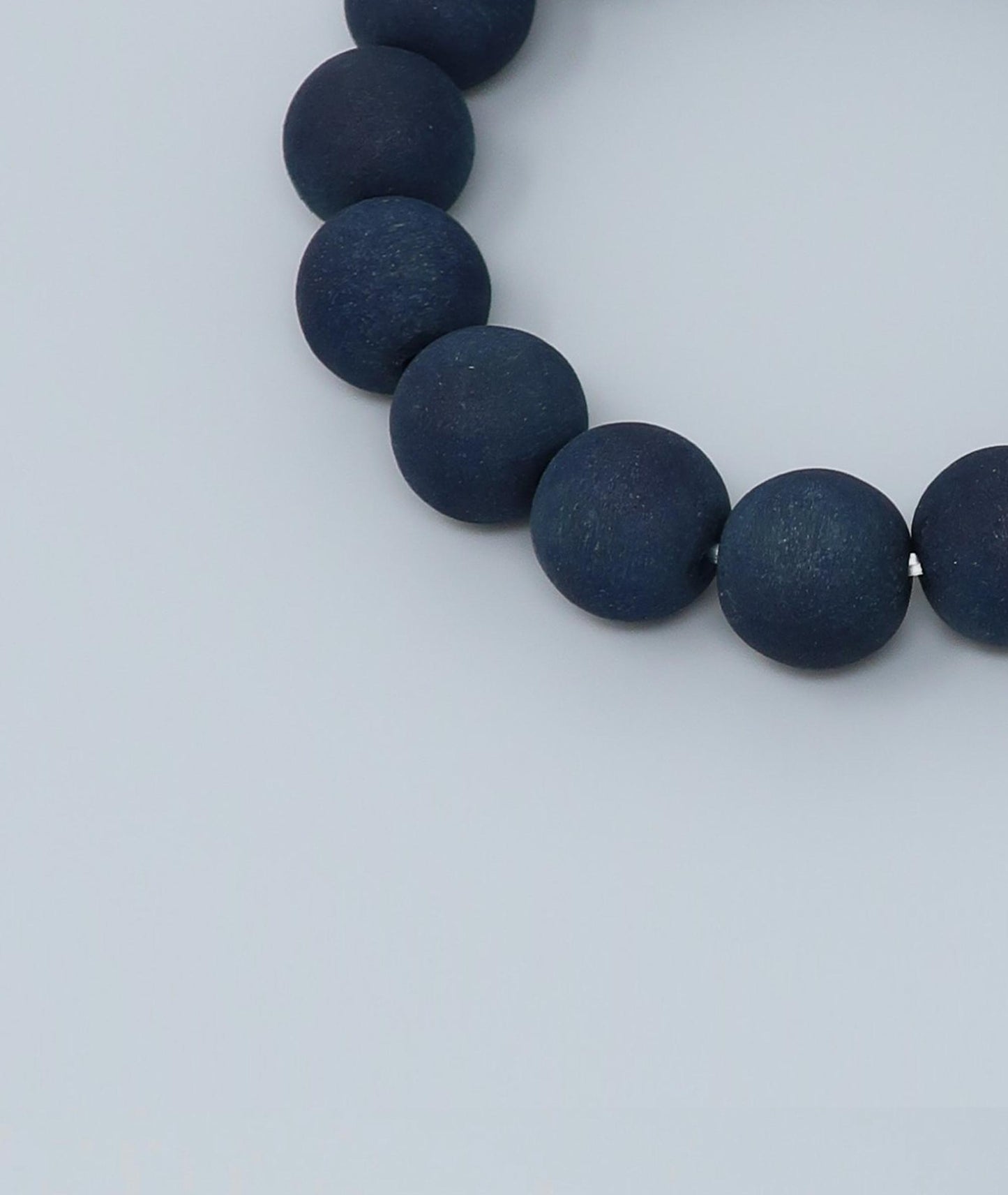 Men's indigo pearl bracelet made from mountain cherry wood, handcrafted in Japan using traditional Sho-Aizome indigo dyeing by Kanbe Juzu of Kyoto; spiritual accessory inspired by samurai, ideal for yoga, prayer, or as a premium gift.