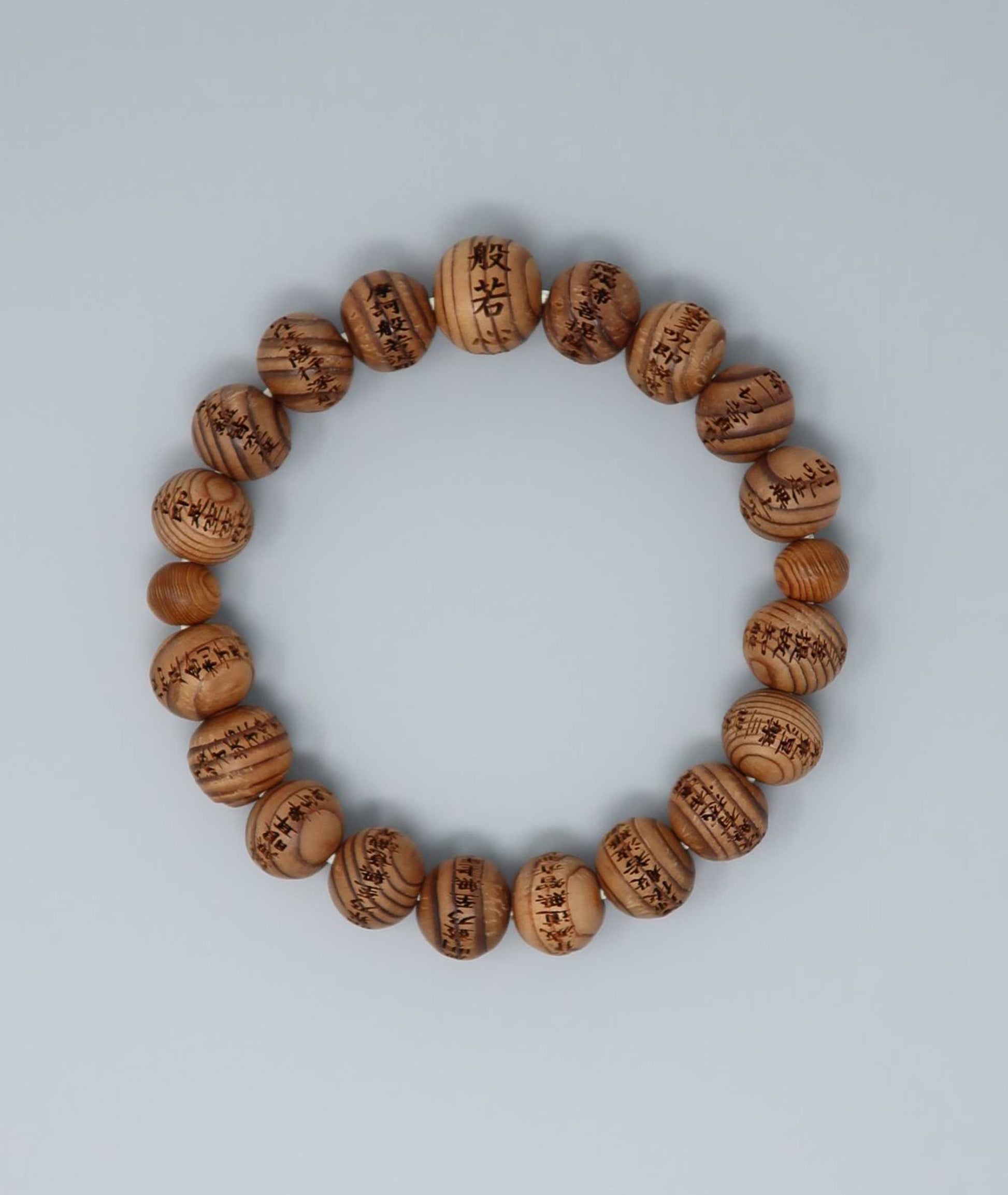 All gender Yakusugi cedar bracelet engraved with Heart Sutra script, symbolizing protection and good luck. Handcrafted in Japan Kanbe Juzu, ideal for amulet, yoga, meditation, prayer, or gifting.