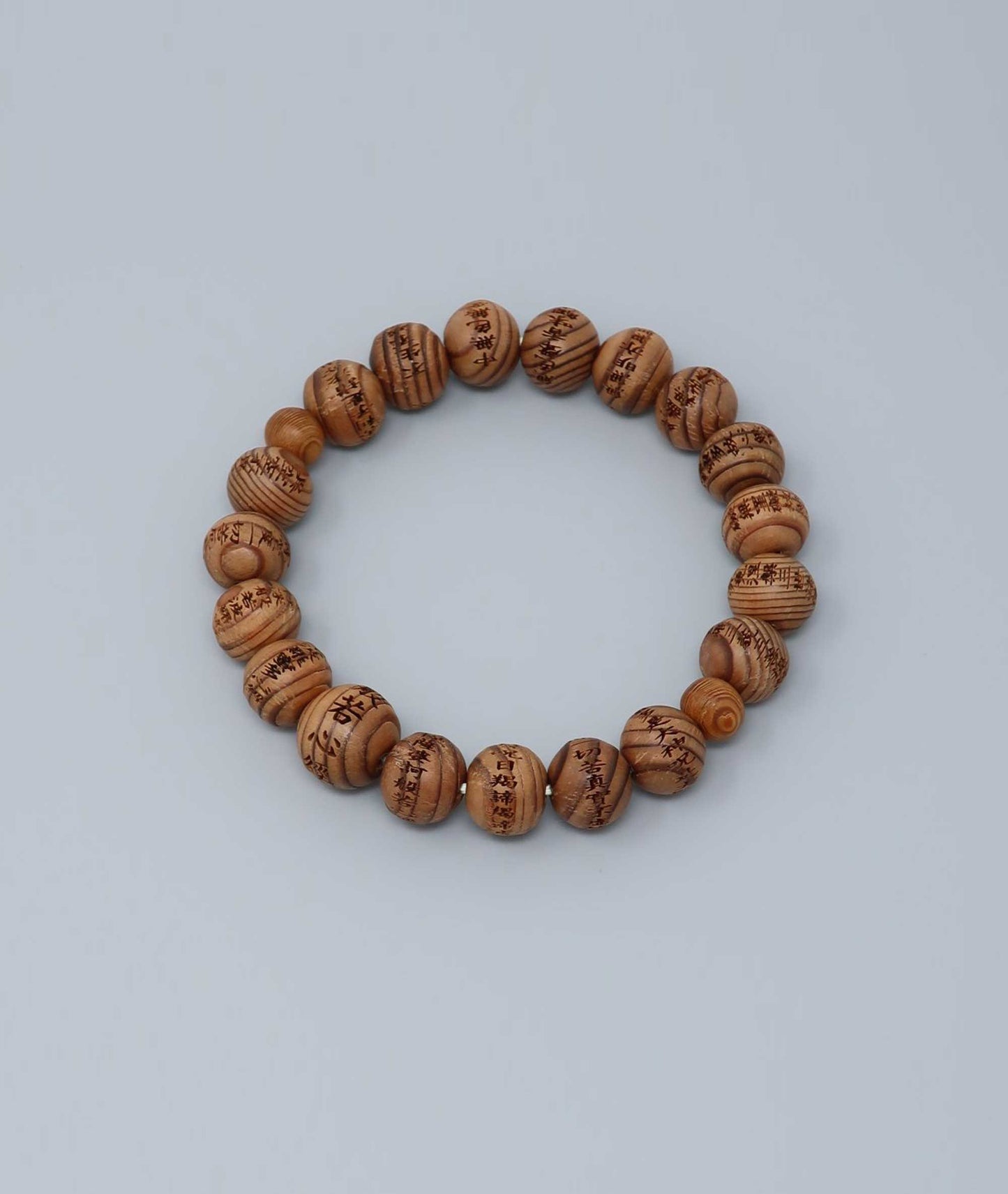 All gender Yakusugi cedar bracelet engraved with Heart Sutra script, symbolizing protection and good luck. Handcrafted in Japan Kanbe Juzu, ideal for amulet, yoga, meditation, prayer, or gifting.