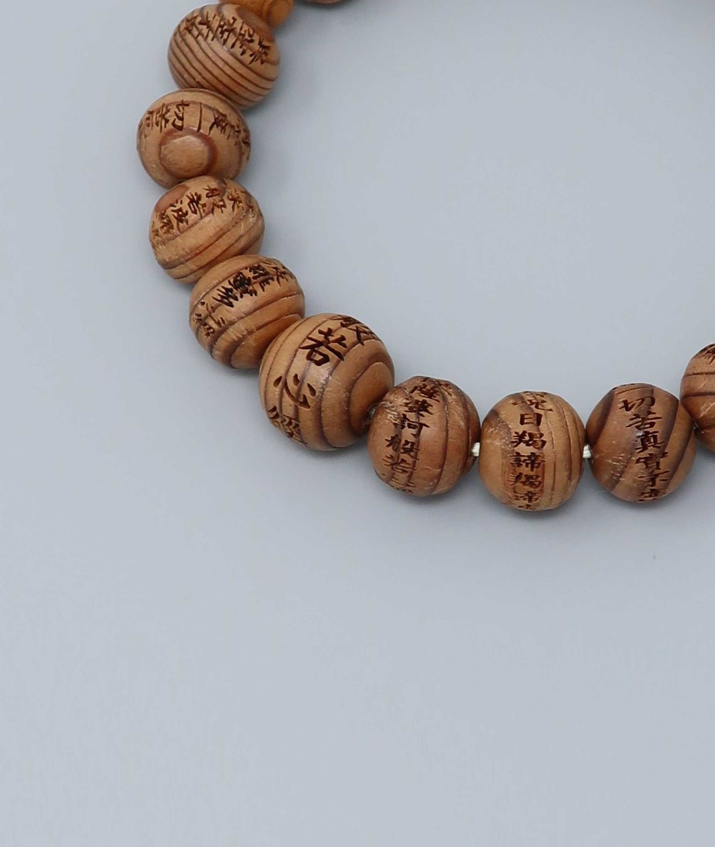 All gender Yakusugi cedar bracelet engraved with Heart Sutra script, symbolizing protection and good luck. Handcrafted in Japan Kanbe Juzu, ideal for amulet, yoga, meditation, prayer, or gifting.