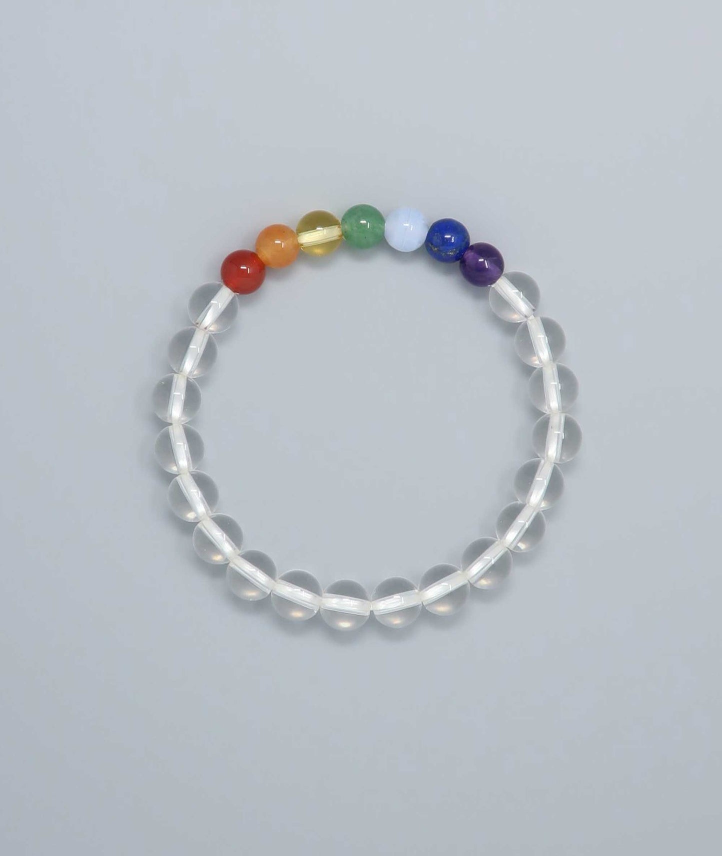 Handcrafted bracelet featuring Japanese clear quartz and seven-colored gemstones representing protection and good fortune. Handcrafted in Japan Kanbe Juzu, ideal for amulet, yoga, meditation, prayer, or gifting.