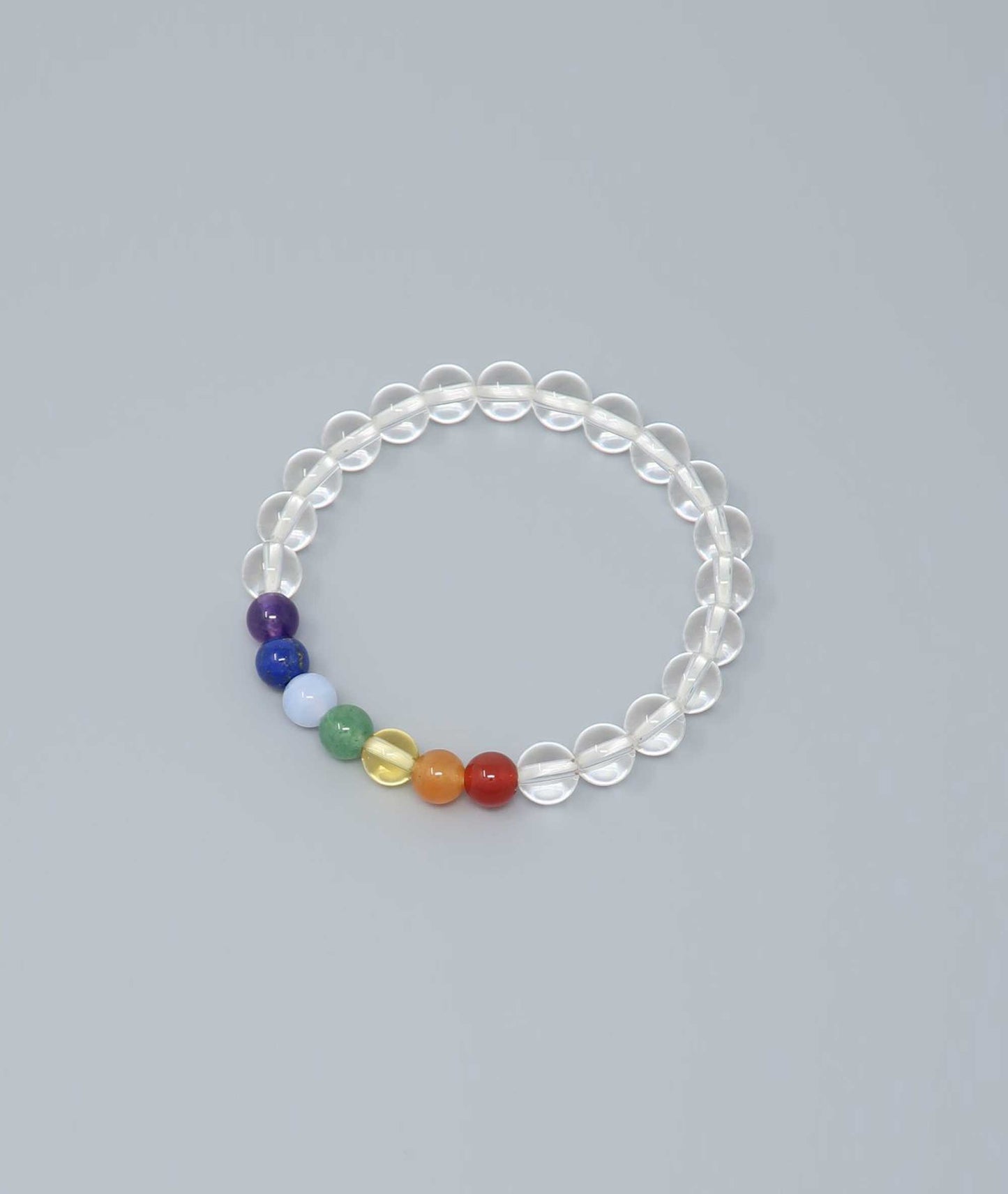 Handcrafted bracelet featuring Japanese clear quartz and seven-colored gemstones representing protection and good fortune. Handcrafted in Japan Kanbe Juzu, ideal for amulet, yoga, meditation, prayer, or gifting.