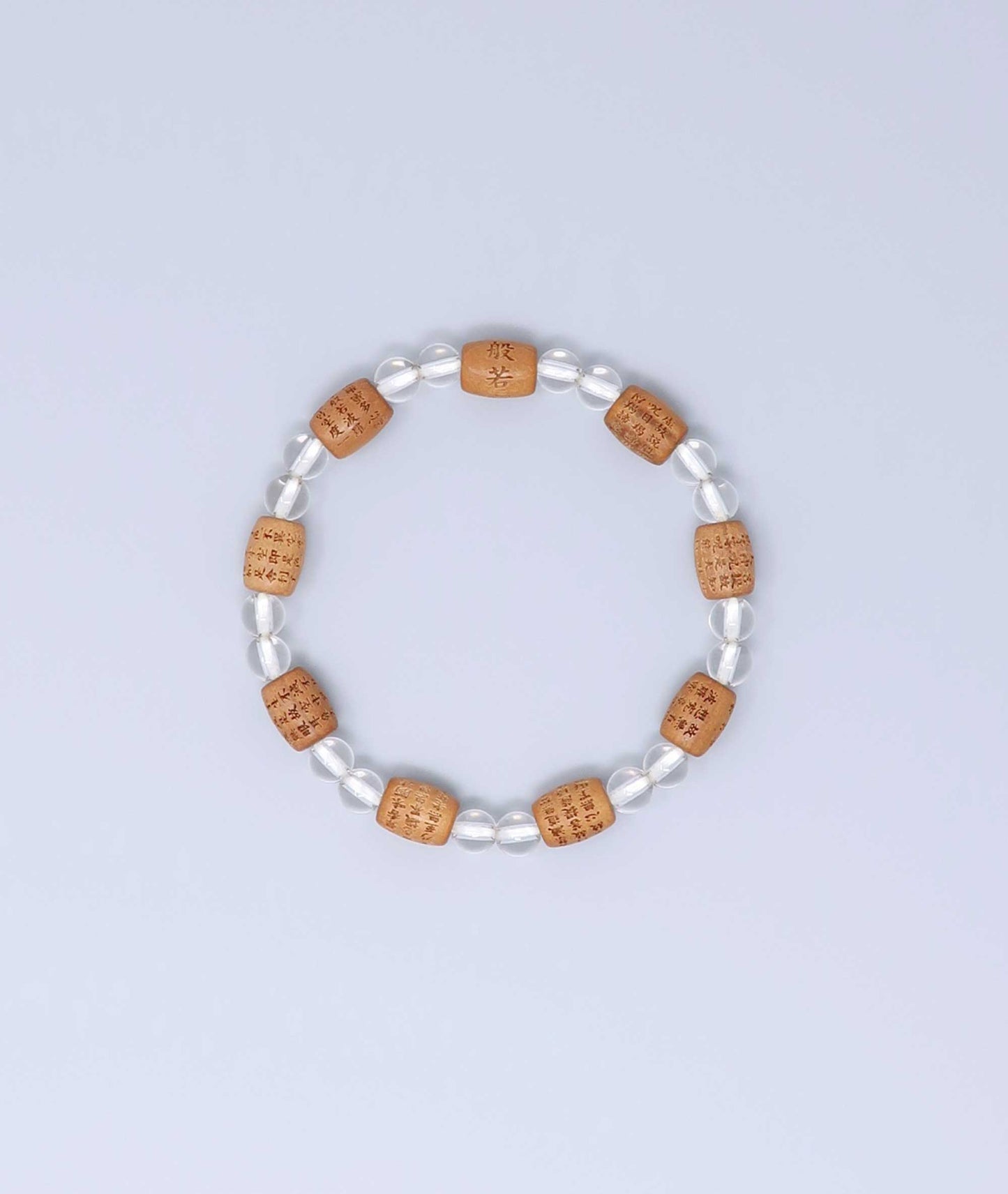 Sandalwood bracelet engraved with the Heart Sutra and accented with a Clear Quartz bead—handcrafted for spiritual protection and harmony. Handcrafted in Kyoto Japan Kanbe Juzu