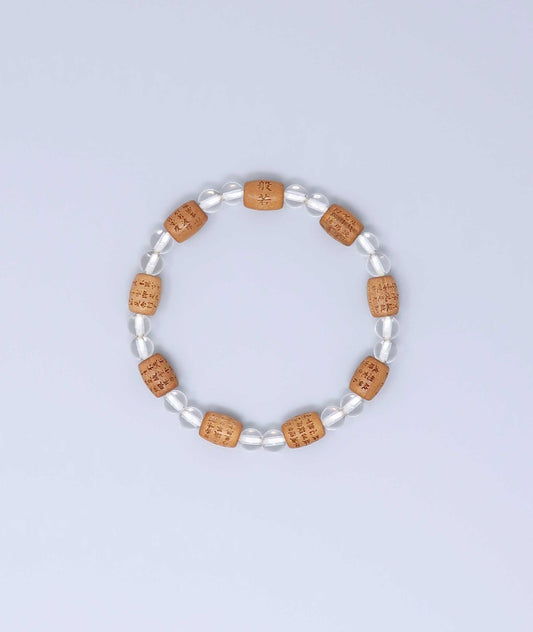 Sandalwood bracelet engraved with the Heart Sutra and accented with a Clear Quartz bead—handcrafted for spiritual protection and harmony. Handcrafted in Kyoto Japan Kanbe Juzu