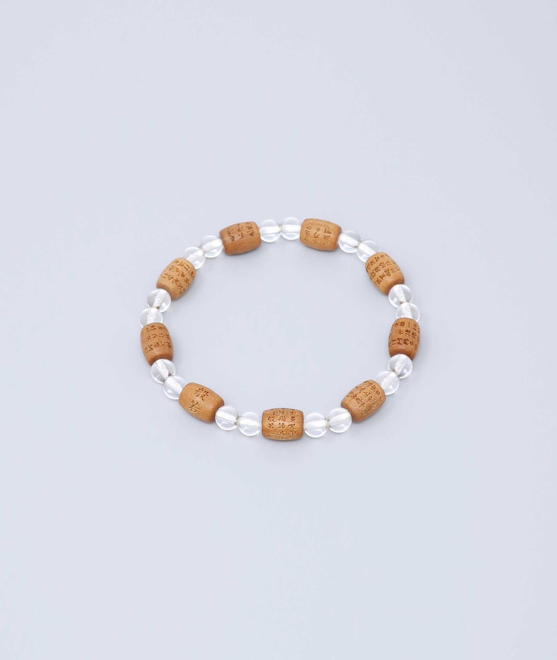 Sandalwood bracelet engraved with the Heart Sutra and accented with a Clear Quartz bead—handcrafted for spiritual protection and harmony. Handcrafted in Kyoto Japan Kanbe Juzu