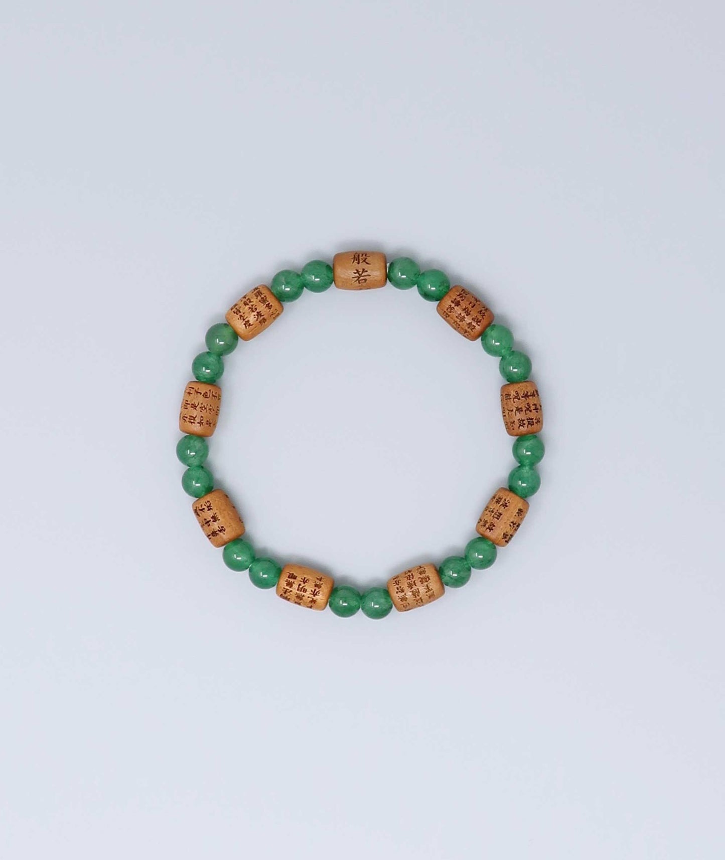 Sandalwood bracelet engraved with the Heart Sutra and accented with a jade bead—handcrafted for spiritual protection and harmony. Handcrafted in Kyoto Japan Kanbe Juzu