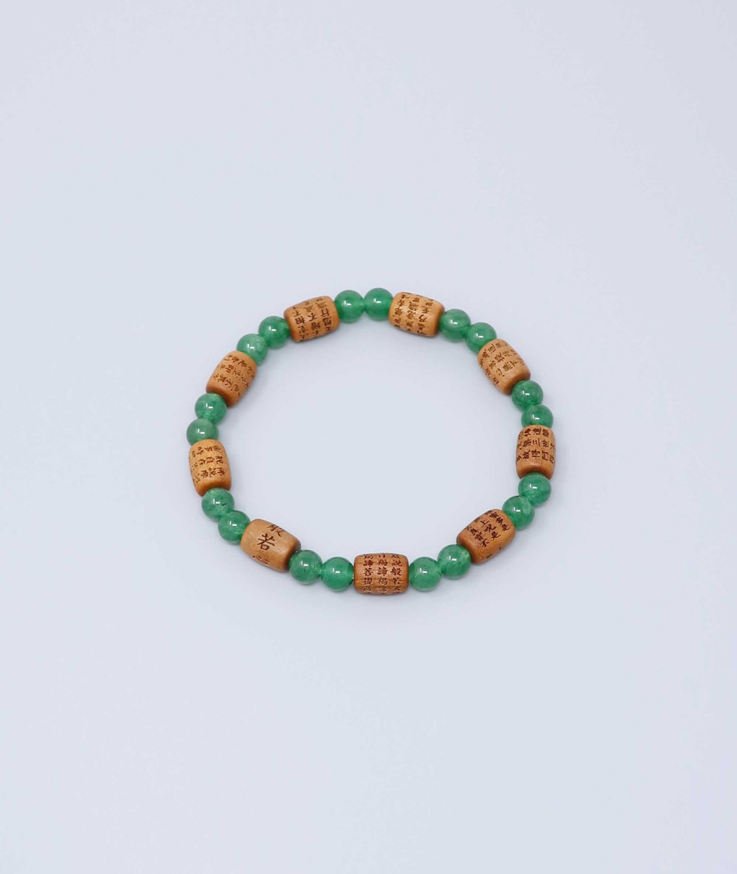 Sandalwood bracelet engraved with the Heart Sutra and accented with a jade bead—handcrafted for spiritual protection and harmony. Handcrafted in Kyoto Japan Kanbe Juzu