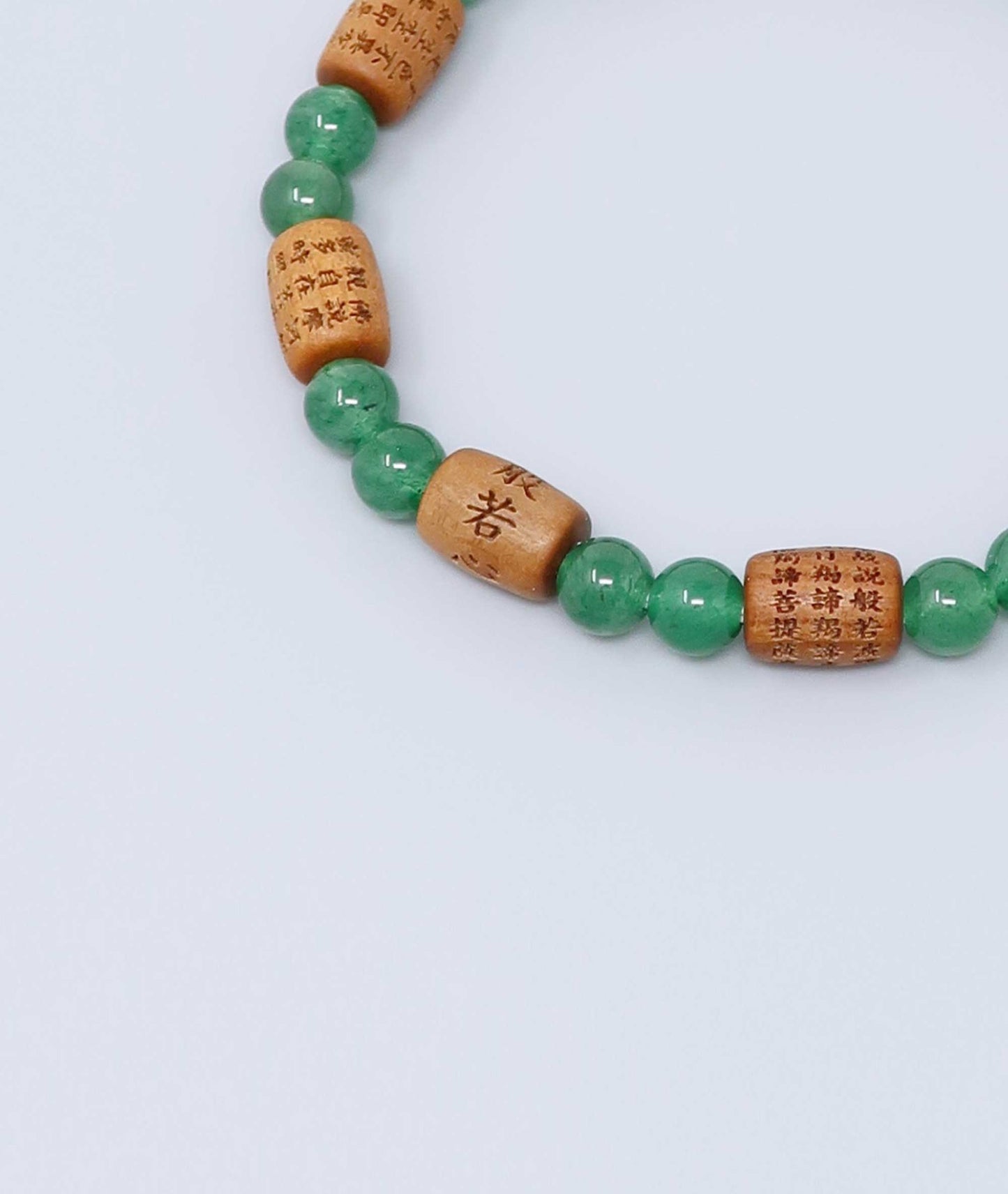 Sandalwood bracelet engraved with the Heart Sutra and accented with a jade bead—handcrafted for spiritual protection and harmony. Handcrafted in Kyoto Japan Kanbe Juzu