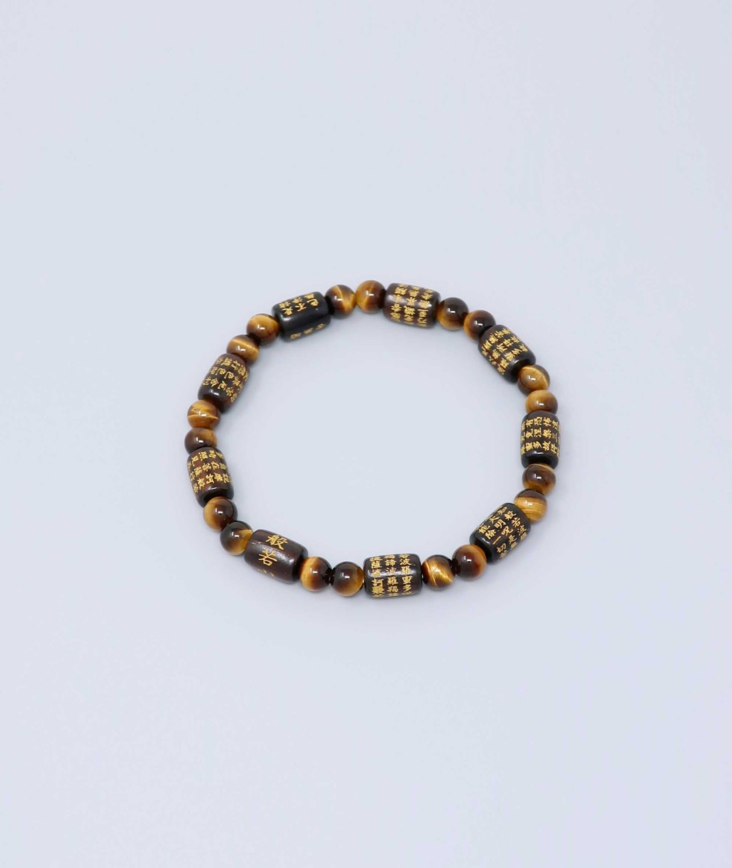 Striped ebony bracelet with Heart Sutra engraving and Tiger’s Eye beads, handmade for spiritual protection and strength. Handcrafted in Kyoto Japan Kanbe Juzu