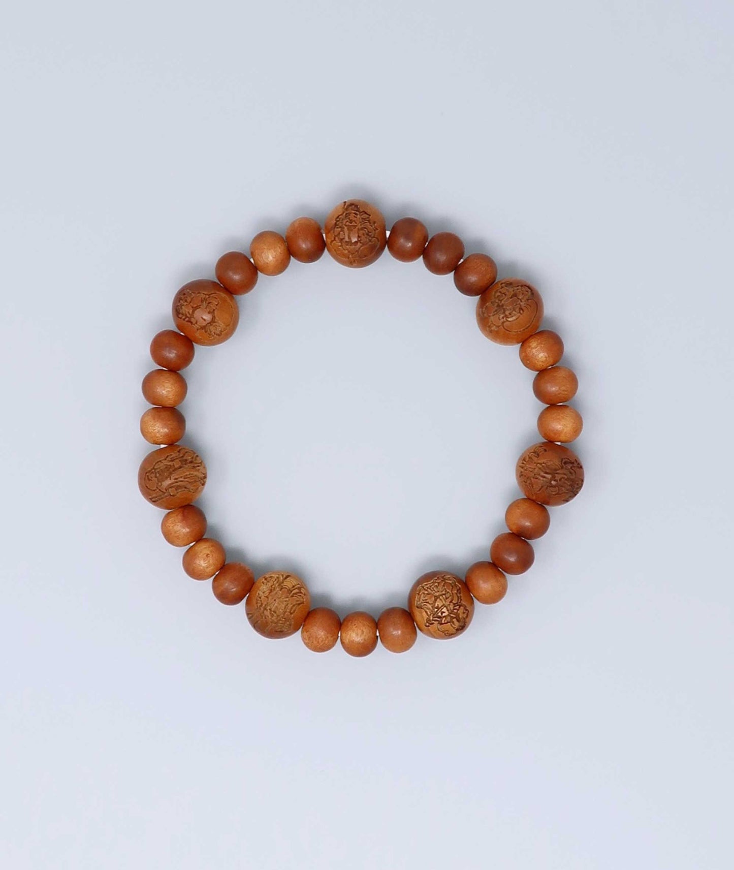 Sandalwood prayer beads mala bracelet with carvings of Japan’s Seven Lucky Gods, known for a calming scent and spiritual symbolism. Handcrafted in Japan Kanbe Juzu, ideal for amulet, yoga, meditation, prayer, or gifting.