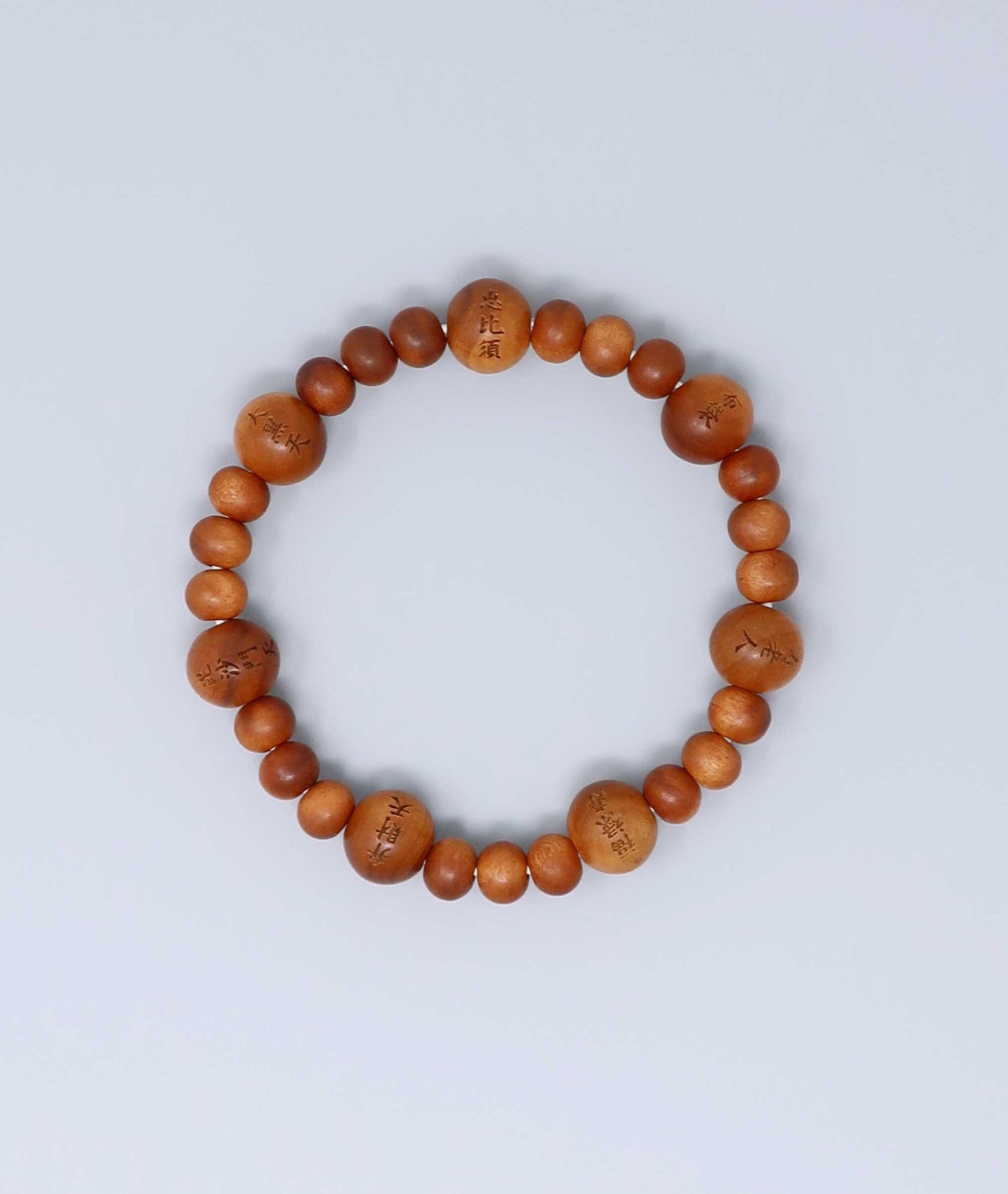 Sandalwood prayer beads mala bracelet with carvings of Japan’s Seven Lucky Gods, known for a calming scent and spiritual symbolism. Handcrafted in Japan Kanbe Juzu, ideal for amulet, yoga, meditation, prayer, or gifting.