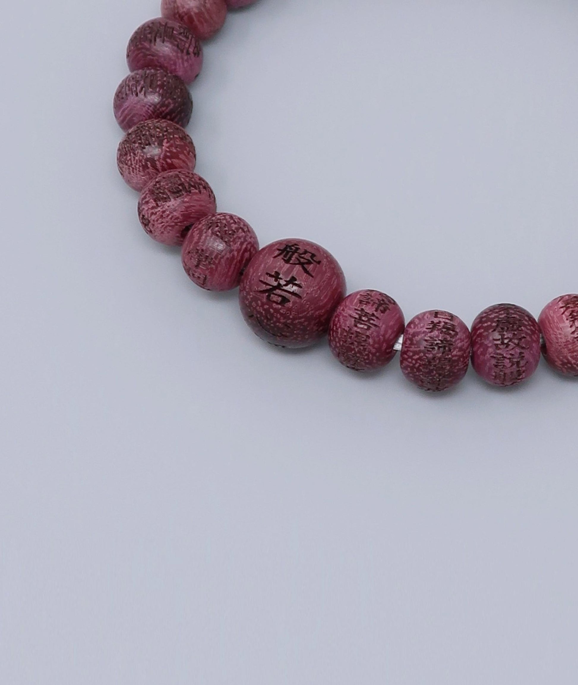 Unisex Buddhist prayer bracelet made from Purpleheart wood, engraved with the full Heart Sutra – a handmade spiritual mala for meditation, protection, and mindfulness. Handcrafted in Japan Kanbe Juzu, ideal for amulet, yoga, meditation, prayer, or gifting.