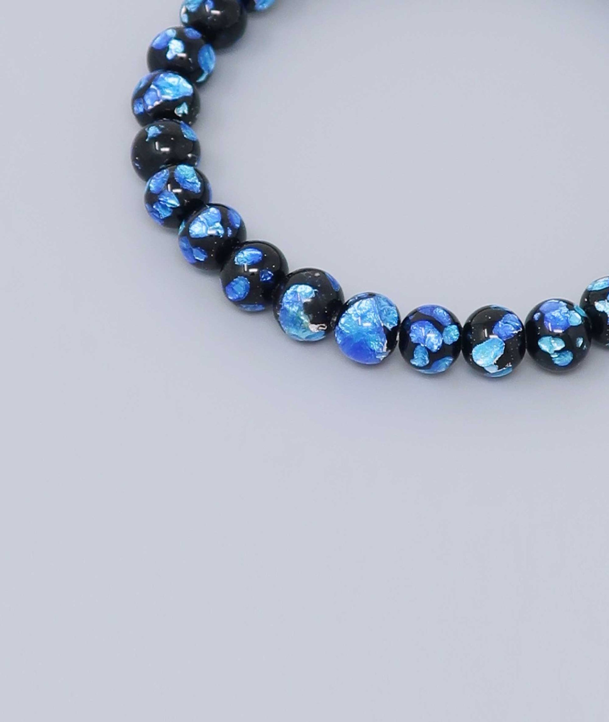 Elegant Blue Ryukyu fluorite bracelet with shimmering light blue accents on a jet-black base. Handmade by artisans, combining mystique and luxury. Handcrafted in Japan Kanbe Juzu, ideal for amulet, yoga, meditation, prayer, or gifting.