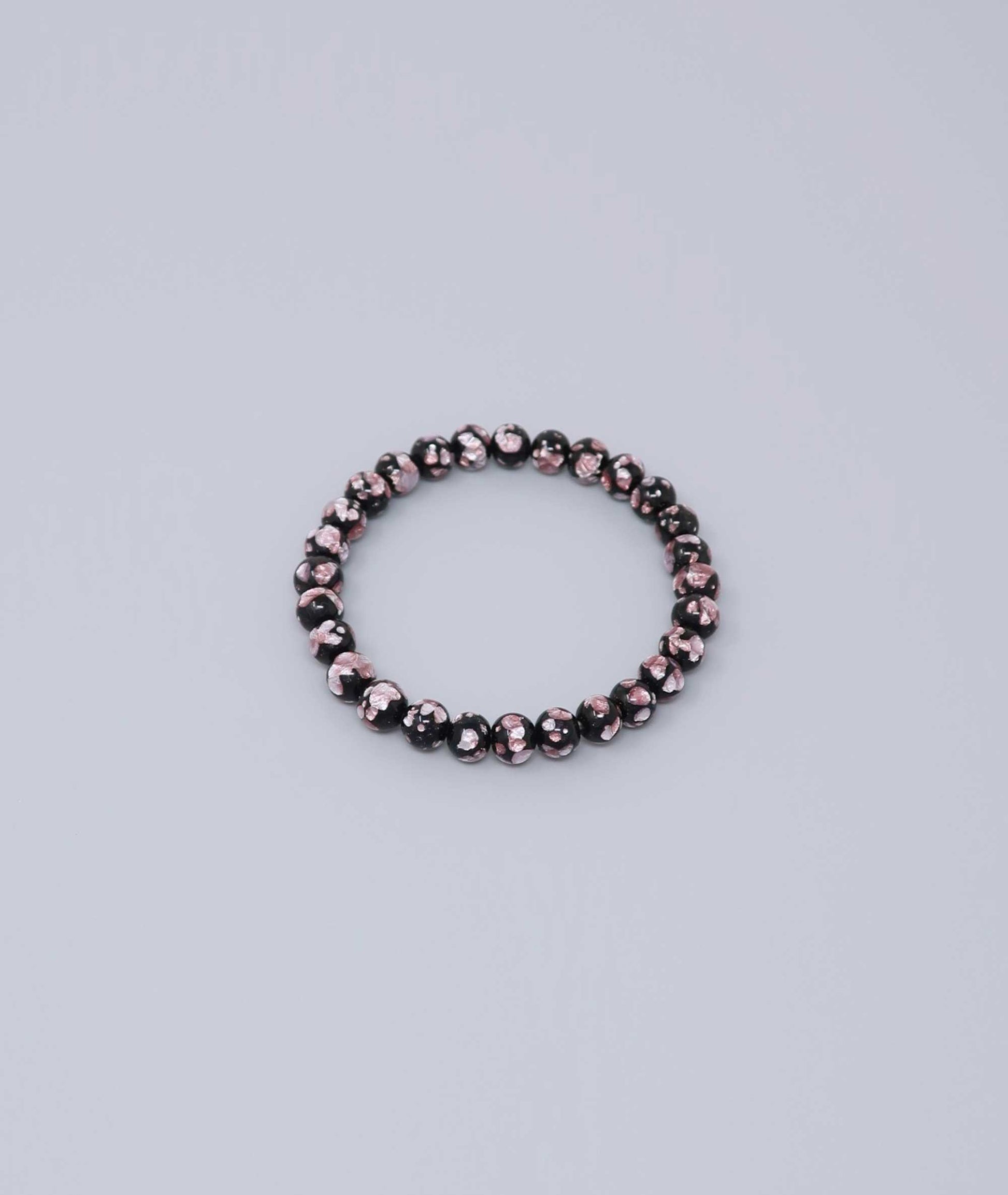 Elegant pink Ryukyu fluorite bracelet with shimmering light pink accents on a jet-black base. Handmade by artisans, combining mystique and luxury. Handcrafted in Japan Kanbe Juzu, ideal for amulet, yoga, meditation, prayer, or gifting.