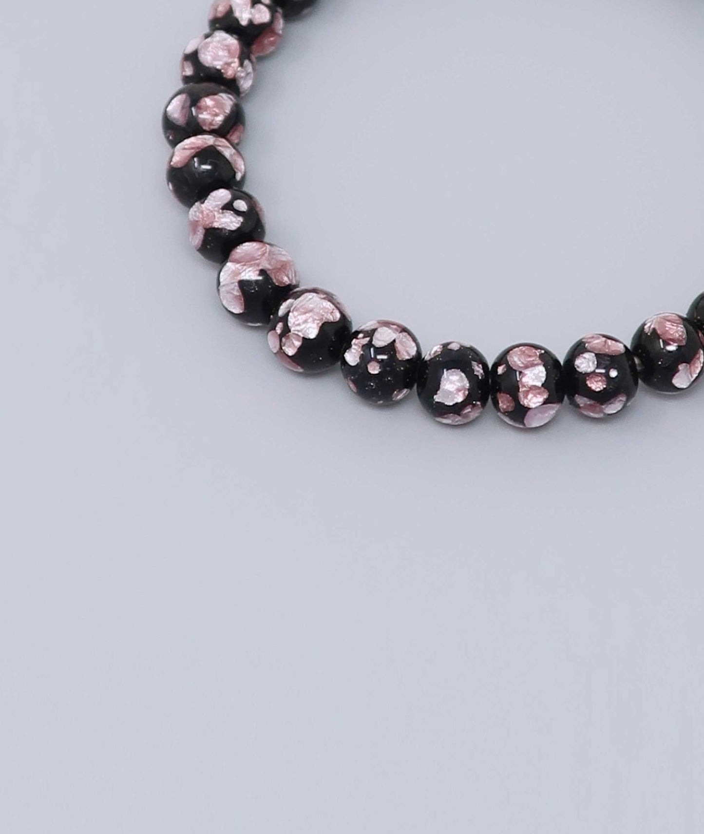Elegant pink Ryukyu fluorite bracelet with shimmering light pink accents on a jet-black base. Handmade by artisans, combining mystique and luxury. Handcrafted in Japan Kanbe Juzu, ideal for amulet, yoga, meditation, prayer, or gifting.