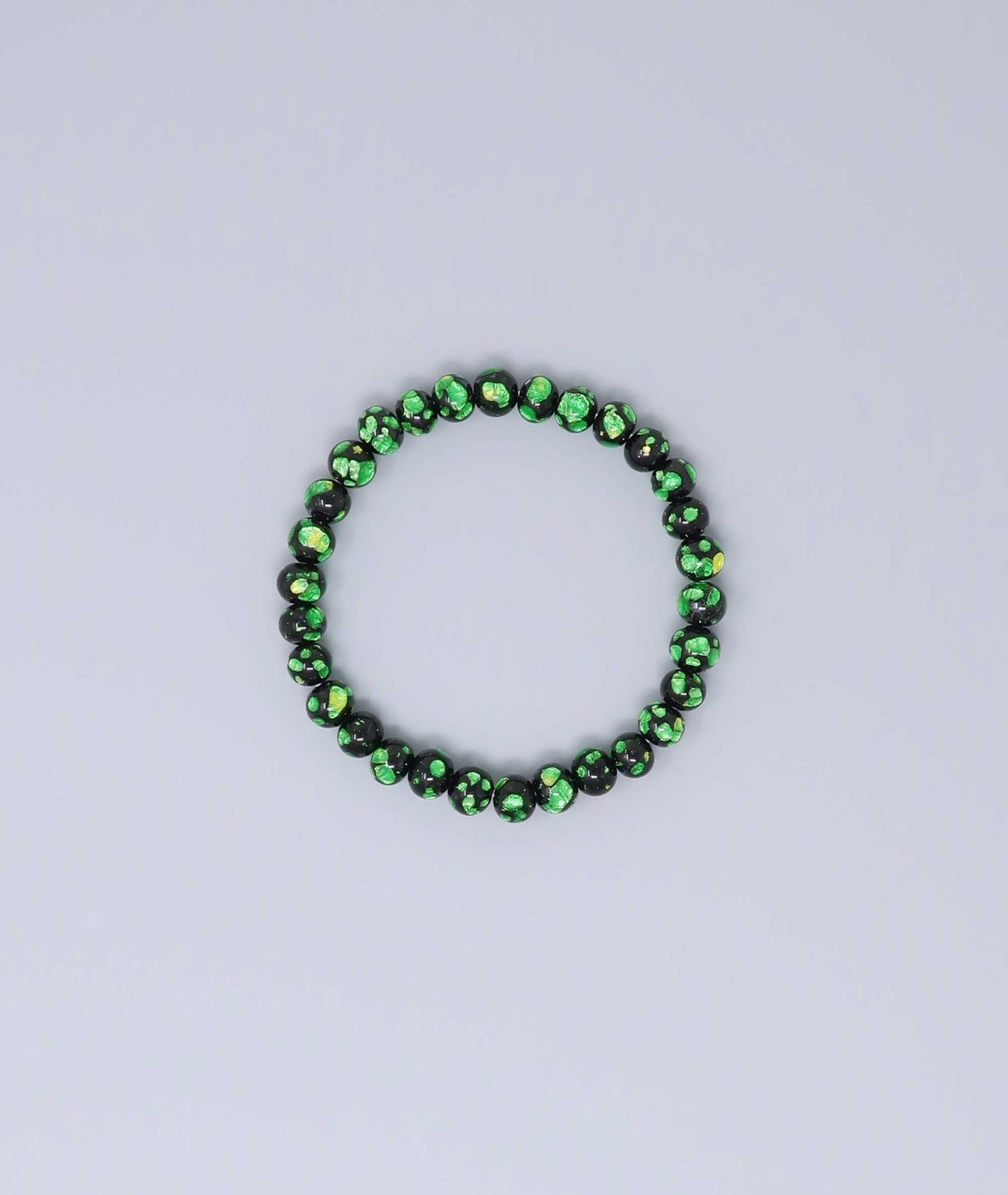 Elegant green Ryukyu fluorite bracelet with shimmering green accents on a jet-black base. Handmade by artisans, combining mystique and luxury. Handcrafted in Japan Kanbe Juzu, ideal for amulet, yoga, meditation, prayer, or gifting.
