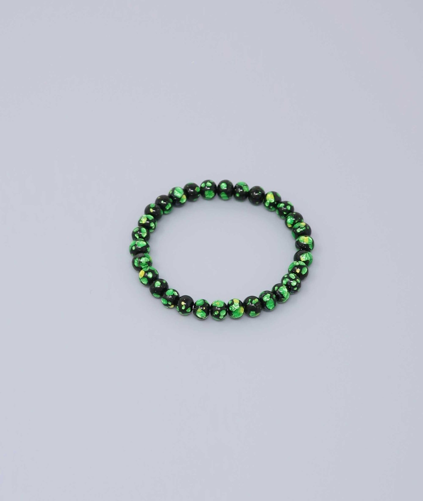 Elegant green Ryukyu fluorite bracelet with shimmering green accents on a jet-black base. Handmade by artisans, combining mystique and luxury. Handcrafted in Japan Kanbe Juzu, ideal for amulet, yoga, meditation, prayer, or gifting.