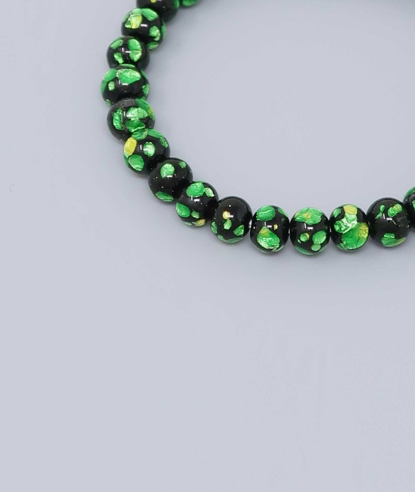 Elegant green Ryukyu fluorite bracelet with shimmering green accents on a jet-black base. Handmade by artisans, combining mystique and luxury. Handcrafted in Japan Kanbe Juzu, ideal for amulet, yoga, meditation, prayer, or gifting.